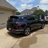 Rear three-quarter view of a dark Genesis SUV