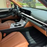 Front passenger seat and dashboard with brown leather interior